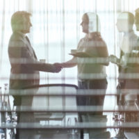 handshake in board room