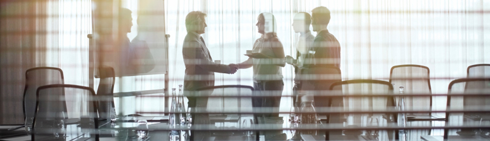 handshake in board room