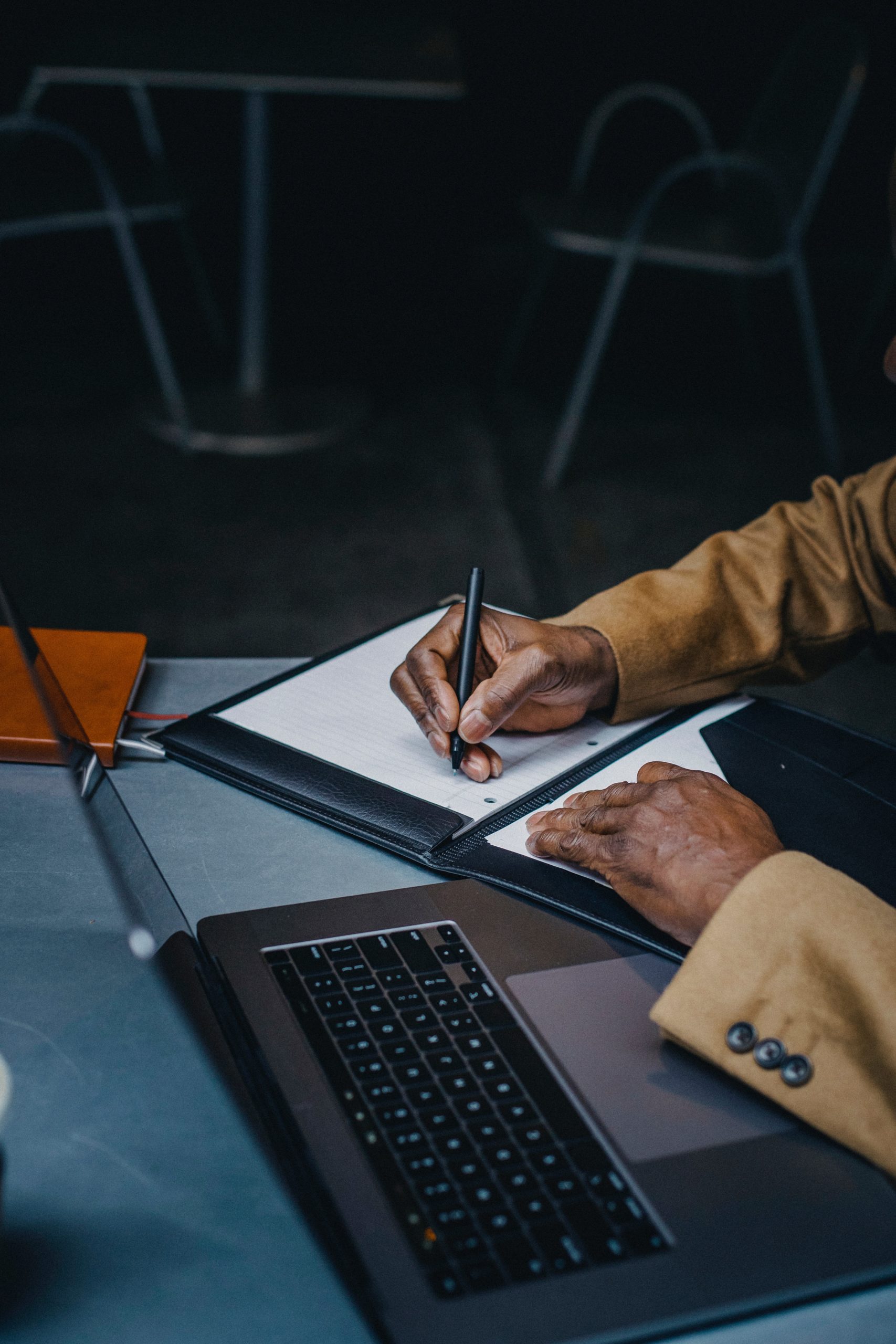 Closeup of a person making notes in a notebook.