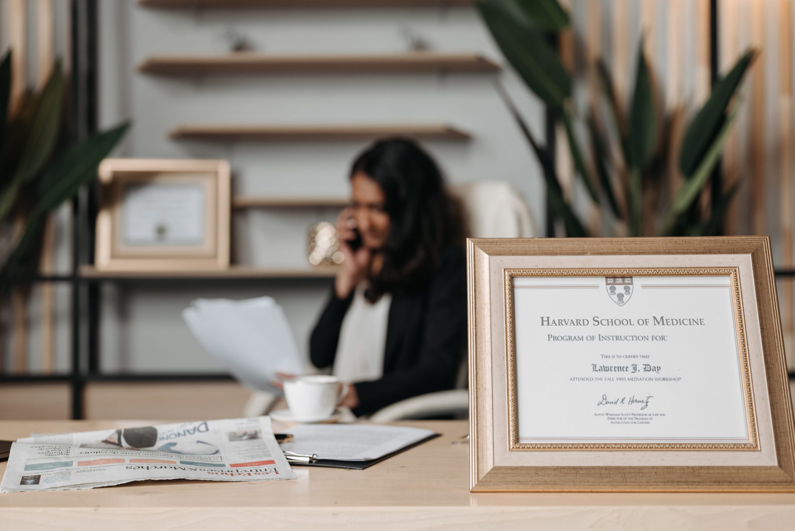 Medical license in frame on desk