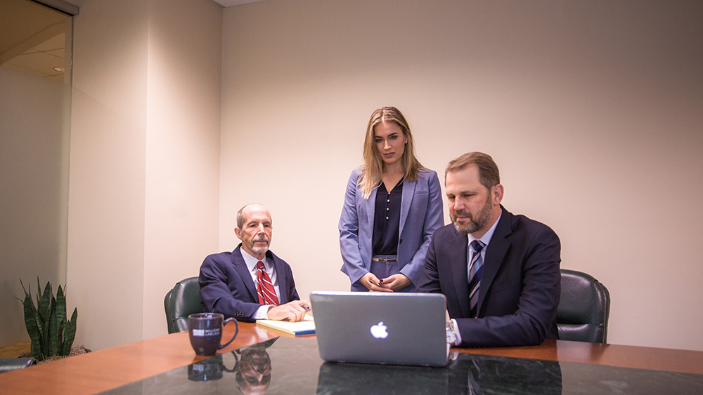 Attorneys looking at laptop screen