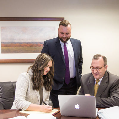 Milligan Lawless attorneys working at desk