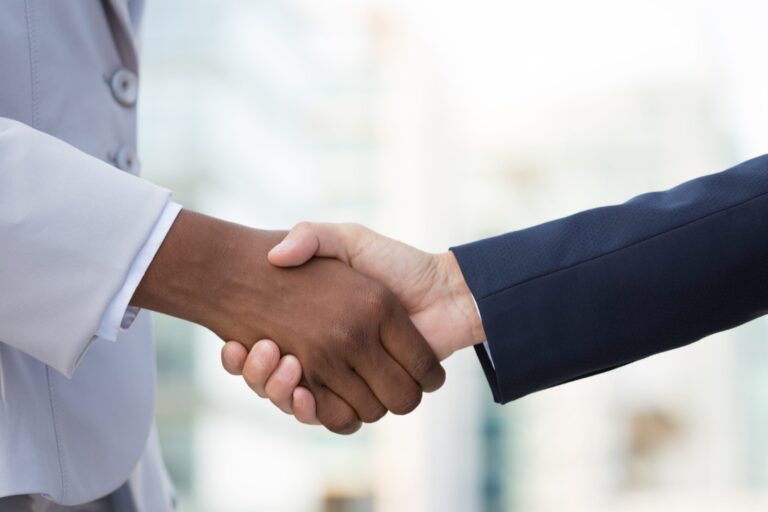 Multiethnic female leaders greeting each other